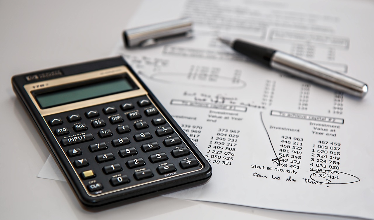 Reviewing a property letter report with a calculator